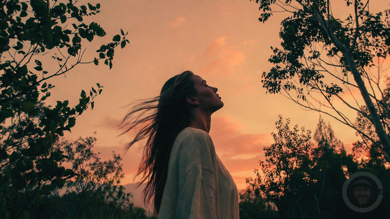 young woman alone looking at the sky in peace
